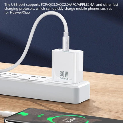 REMAX Charger for Daily Device Powering at Home and Travel - white 30W dual-port fast USB charger shown plugged into power strip charging phone