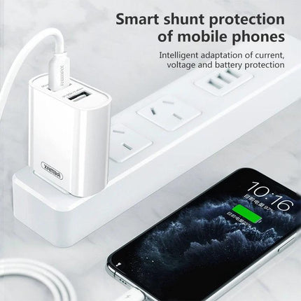 Charge Your Devices with This REMAX Set for Daily Use - white dual USB REMAX charger powering phone on power strip