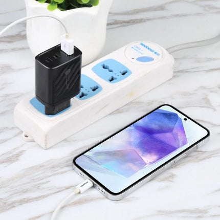 Essential charger for home and travel device needs plugged into power strip charging smartphone with three-port USB adapter