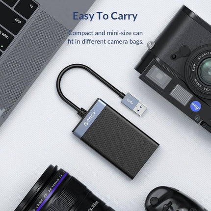Orico 4-in-1 USB-C Multifunction Card Reader for Simultaneous Use compact card reader beside camera and laptop for photographers