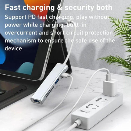 Compact Docking Station for Everyday iPhone Data Transfers connected to iPad and power strip, showing USB ports and fast charging setup