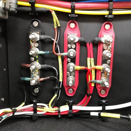 RV Power Distribution Terminal Block With Cover M8 and M10 Studs installed in vehicle panel with labeled wires and cable management