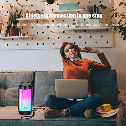 TG Bluetooth Speaker For Home Listening And Hands Free Calls on sofa near laptop providing hands-free calls and background music