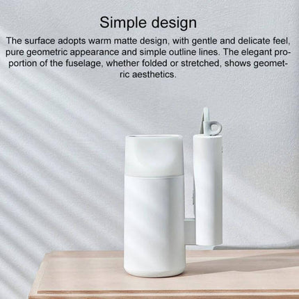 Xiaomi Mijia Negative Ion Portable Hair Dryer With Foldable Handle shown folded on a table, matte white compact travel design
