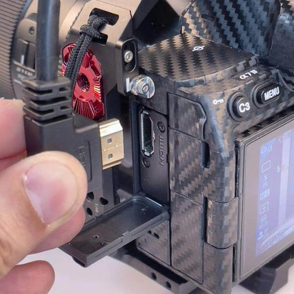 30cm HDMI Male to Female Elbow Adapter Cable with 90-Degree Angle shown connecting HDMI to camera in tight space