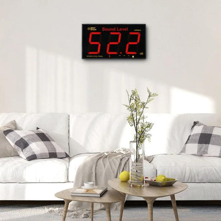 SmartSensor Wall Mounted Sound Level Meter for Noise Monitoring mounted above living room sofa showing 52.2 dB display