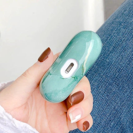 Marble Protective Case for Everyday Earphone Protection in green marble finish held in hand showing charging port access