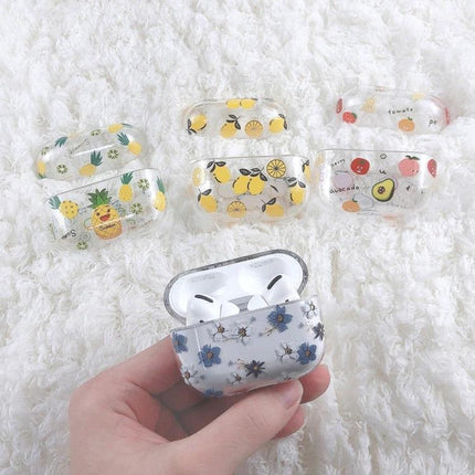 Fruit-Patterned Protective Case for Everyday Earbud Use — clear fruit-design earbud case set shown on white rug, hands holding floral variant
