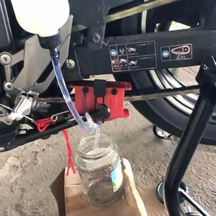 Motorcycle Chain Cleaning Kit For Chains And Sprockets applying cleaner and lubricant to motorcycle chain and sprocket with drip jar to minimize fling