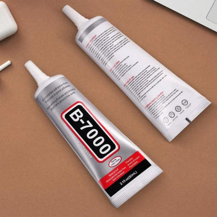 B-7000 Multi-Purpose Adhesive Glue for Everyday Material Bonding tube of transparent adhesive on brown surface for electronics and crafts