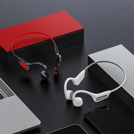 Bone Conduction Open Ear Wireless Earphones For Running And Commuting shown in red and white on desk with laptop and phone