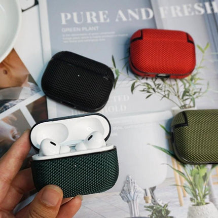 Waterproof Nylon Case for Everyday Earphone Protection and Travel - textured green case holding white earbuds, plus red black olive cases on magazine