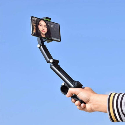 Multifunctional Car Sun Visor Mobile Phone Holder Green – foldable 1080° rotating clamp mounted on hand against blue sky for hands-free navigation and calls