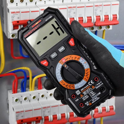 HABOTEST Portable Digital Multimeter for Electrical Testing handheld multimeter with clear LCD held by gloved hand near circuit breakers