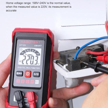 HABOTEST Mini Digital Multimeter for Electrical Measurements showing 220.3V AC reading on a compact red multimeter during home wiring test