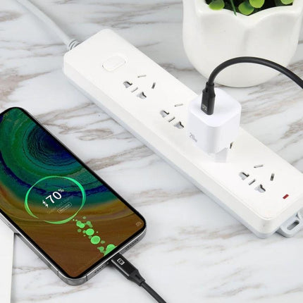 Essential EU Plug USB-C Charger for Everyday Device Needs - white charger plugged into EU power strip charging smartphone on marble surface