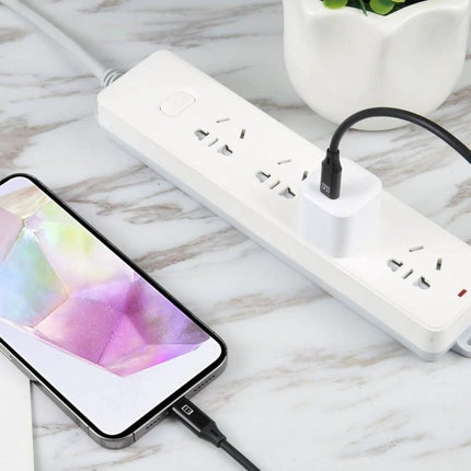Essential USB-C Charger for Everyday Device Powering Needs — compact 20W white charger powering smartphone on power strip