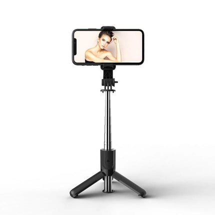 A Compact Selfie Stick for Everyday Outings and Travel - foldable Bluetooth tripod selfie stick holding smartphone for vlogging and group photos