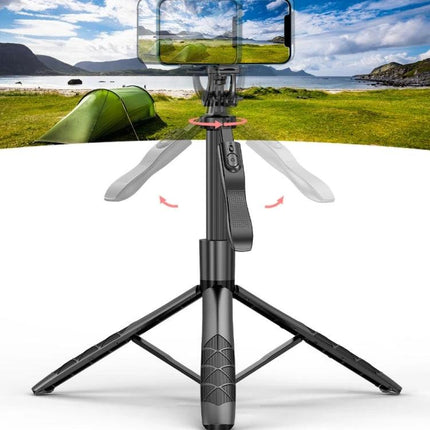 Foldable Selfie Stick Tripod for Everyday Travel Photos showing compact tripod with phone mount set up on grass by a campsite