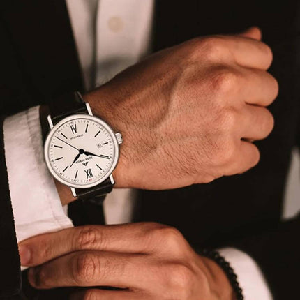 North Edge Business Men's Waterproof Leather Watch on a suited man's wrist, black cowhide strap and stainless steel case