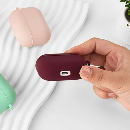 Protective Silicone Case for Earbuds During Daily Activities shown in burgundy being held, with mint and blush cases nearby, 360-degree coverage
