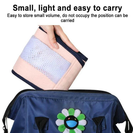 Baby Front Sling Carrier, Portable For 0 To 48 Months - compact folded cotton-polyester sling being placed into a travel bag, lightweight and easy to carry