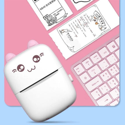 Mini Bluetooth Wireless Thermal Printer for Portable Printing printing cute white mini thermal printer with kawaii face next to printed notes and pink keyboard