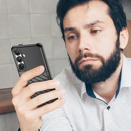 Thunderbolt Phone Case for Samsung Galaxy Daily Protection shown on man holding phone in work setting, textured TPU full-coverage protective case
