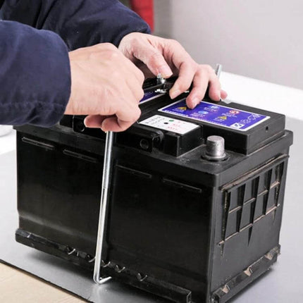 Car Universal Battery Bracket With Adjustable Base Tray installed on automotive battery being tightened for secure, adjustable fit