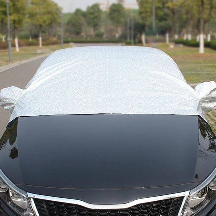 Aluminum Foil Car Sun Cover for UV and Heat Protection placed over a parked car windshield to block sunlight and reduce interior heat