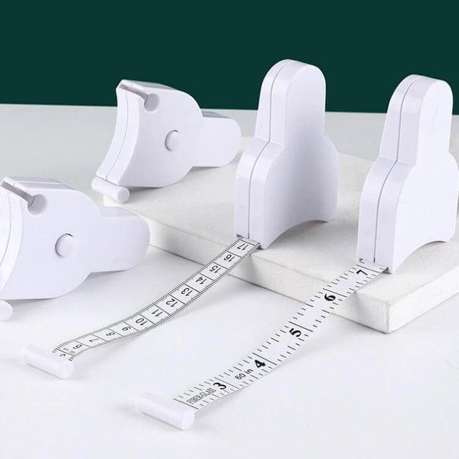 Automatic Precision Waist Measurement Ruler With One Click Reset showing white retractable tape measure on fabric