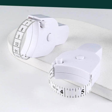 Automatic Precision Waist Measurement Ruler With One Click Reset shown as compact white retractable tape device for sewing, alterations, and fitness tracking