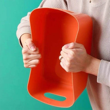 Desktop Snack Storage Basket, Three Sizes For Kitchen And Desk - orange polypropylene basket held to show flexible durable design
