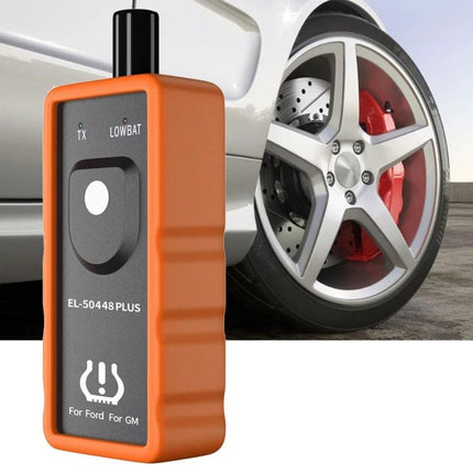 Tire Pressure Reset Device for Everyday Car Maintenance compact orange TPMS activator near car wheel