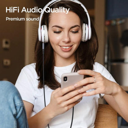 Joyroom USB-C to 3.5mm Adapter Cable for Daily Audio Connections — woman enjoying HiFi music on wired headphones from smartphone using braided cable