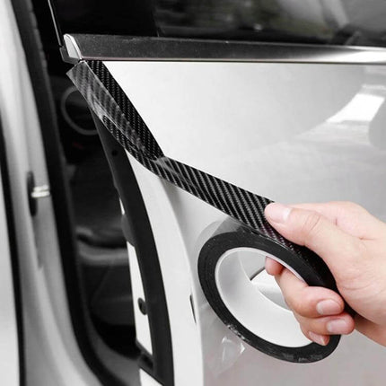 Universal Carbon Fiber Style Car Door Protection Strip Guard applied to car door edge, hand holding carbon fiber acrylic strip tape