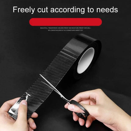 Universal Carbon Fiber Style Car Door Protection Strip Guard - roll of carbon fiber-style acrylic tape being cut with scissors for custom door edge protection
