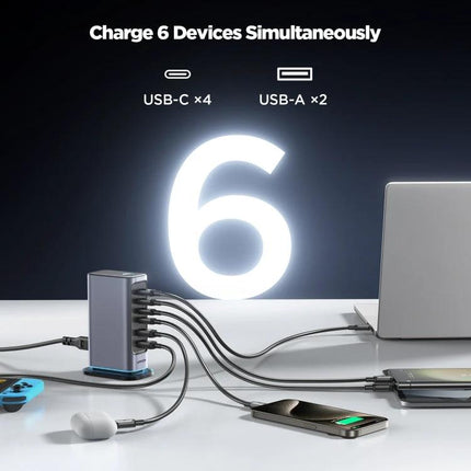 JOYROOM Multi-Port Charger for Daily Home and Travel Use charging six devices simultaneously with 4 USB-C and 2 USB-A ports, shown powering phone, laptop, earbuds (under 140 chars)