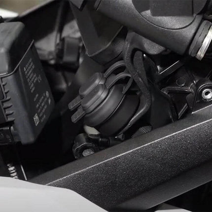 Motorcycle USB Charger Socket With Dual USB Ports For Rides mounted on motorcycle frame showing dual-port socket and protective cap