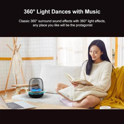 Compact Bluetooth Speaker With Ambient Lighting For Home Use on a cozy sofa with pulsing 360° RGB lights and woman reading