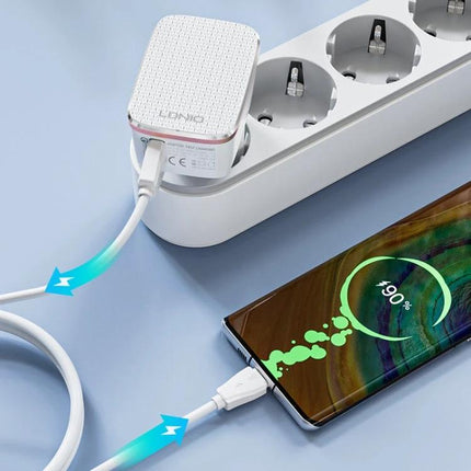 LDNIO Charger for Daily Travel and Device Essentials plugged into power strip charging smartphone at 90% — compact travel wall charger