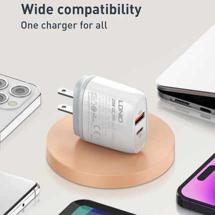 LDNIO Charger for Daily Device Powering with Versatile Plugs compact white 20W USB-C and USB-A travel wall charger beside phones and laptop