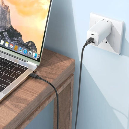 Charge your devices easily with this BOROFONE Type-C cable plugged into a wall charger powering a laptop on a desk