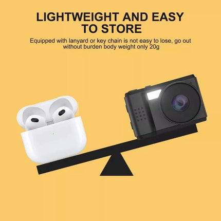 Portable Mini HD Screen Camera for Everyday Photography showing compact camera balanced against earbuds to highlight lightweight design