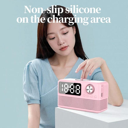 Woman placing phone on pink Bedside Speaker With LED Clock And Wireless Charging Pad showing digital LED time and non-slip pad