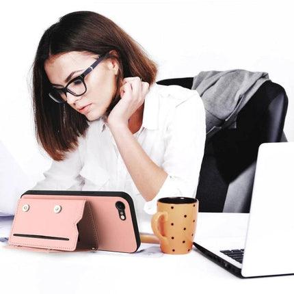 Phone Case With Card Slots For Daily Essentials shown propped as a stand with wrist strap and cards next to a woman working at a desk