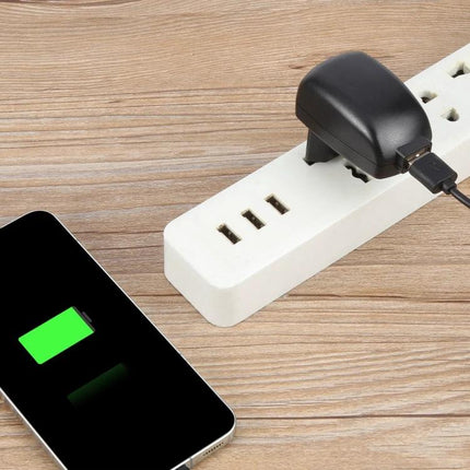 Reliable HYT USB Adapter for Everyday Home Devices powering a phone and router on a power strip, compact black adapter in use