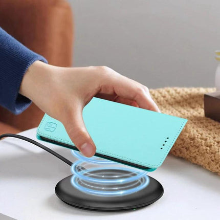 Leather Case For iPhone Everyday Carry Keeps Essentials Organized On The Go Lightweight - turquoise wallet-style iPhone 13 case being placed on wireless charger