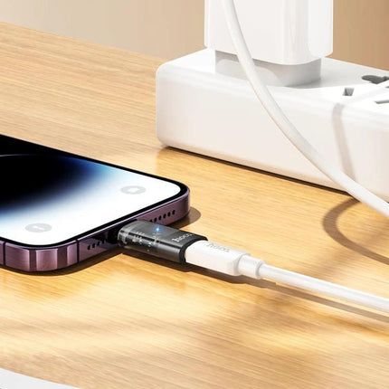 Hoco Adapter for Everyday iPhone to USB-C Connections plugged into iPhone showing translucent adapter for file transfer and charging