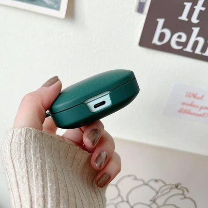 Essential Protective Case for Daily Earphone Travel in matte green held in hand showing charging port and compact design